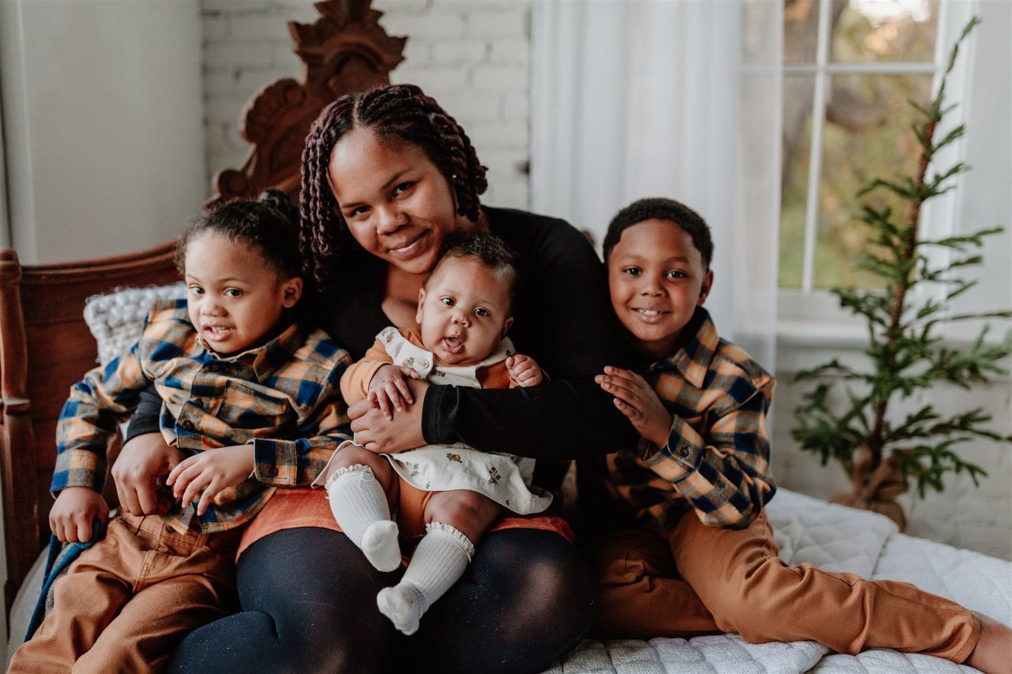 Adrianna, her daughter Brooklyn, and her two sons pose for a photo.