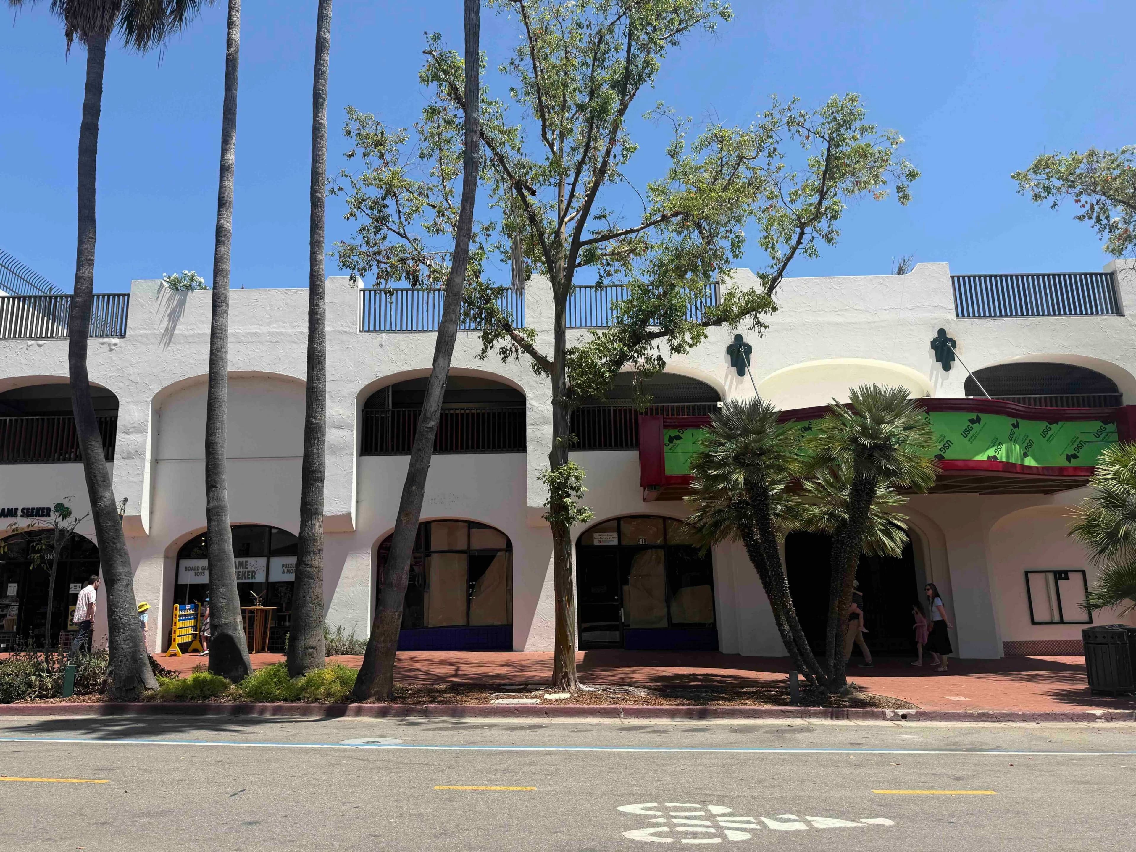 Photo of storefronts of the 900-block of State Street, including the SBIFF Film Center and the future State of Mind Cafe, from the other side of the street.
