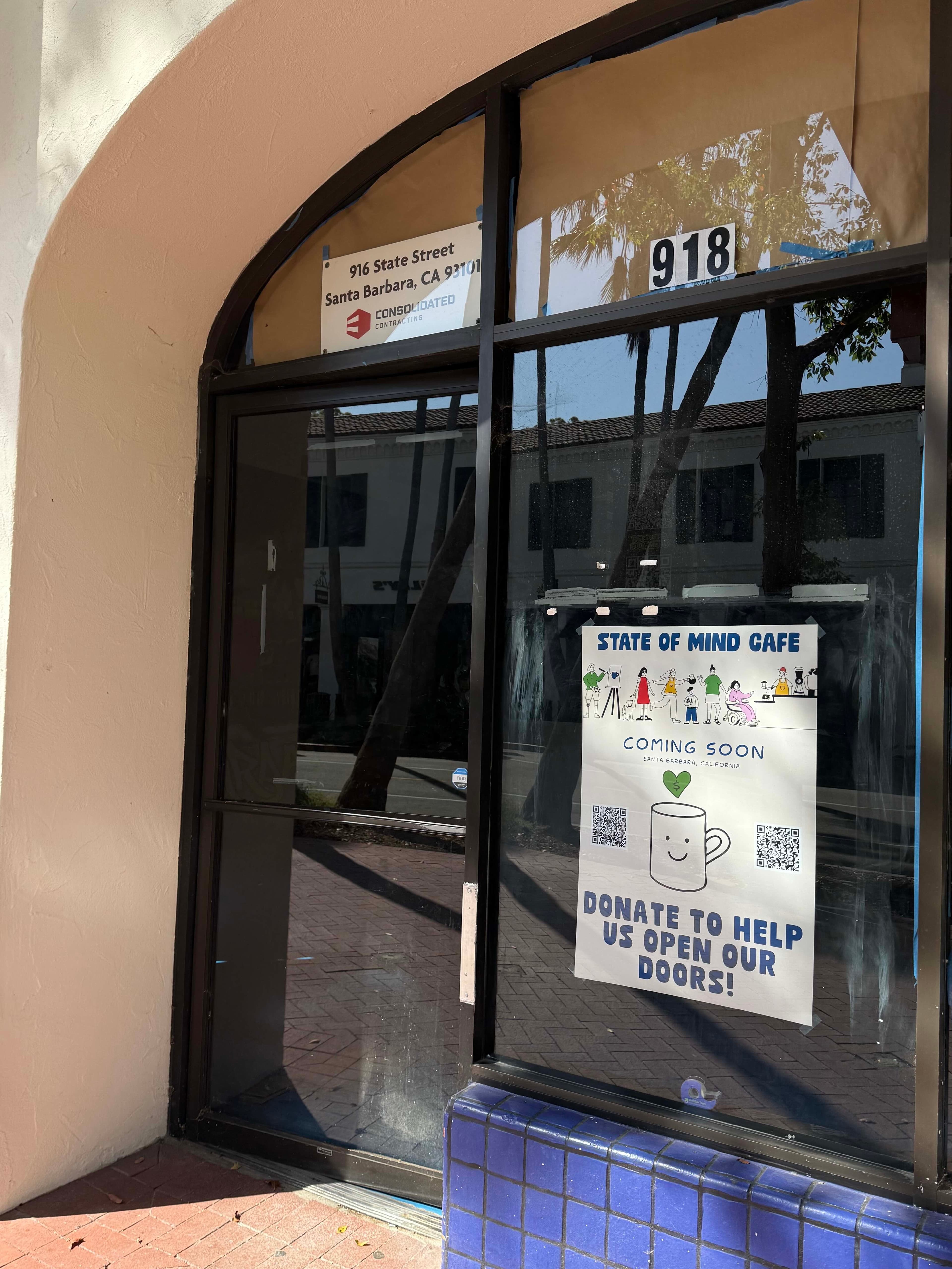Door and window of 918 State Street with a sign that reads: "State of Mind Cafe, Coming Soon, Donate to Help Us Open Our Doors."